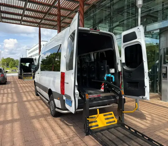Professionele rolstoeltaxi chauffeur helpt klant in Laren